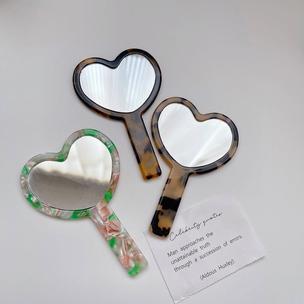 "Reflect your heart" heart-shaped handheld mirror
