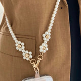 Elegant pearls connect, with a two-way charm. A mobile phone strap & bag chain accented with rose gold petite flowers.