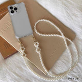 Elegant pearls connect, with a two-way charm. A mobile phone strap & bag chain accented with rose gold petite flowers.