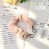 "Add a soft pop of color to your daily essentials" Fluffy smartphone wrist strap with holder sheet