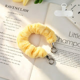 "Add a soft pop of color to your daily essentials" Fluffy smartphone wrist strap with holder sheet