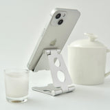 "Lean your back" Folding smartphone/tablet stand