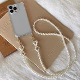 Elegant pearls connect, with a two-way charm. A mobile phone strap & bag chain accented with rose gold petite flowers.