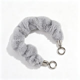 "Add a soft pop of color to your daily essentials" Fluffy smartphone wrist strap with holder sheet